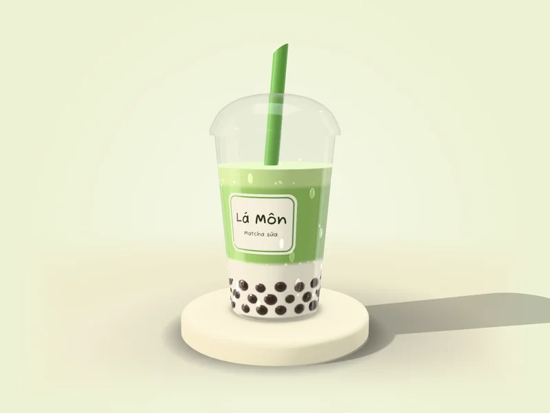 Ly matcha sữa Lá Môn nắp vòm trên bệ kem: matcha xanh cốm nằm trên lớp sữa trắng, trân châu nâu bóng dưới đáy, ống hút xanh